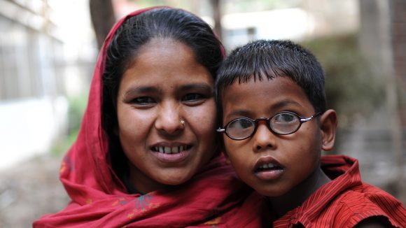 A mother with her son in Dhaka. He is wearing his new spectacles.