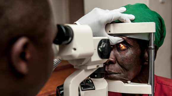 Nazondani Mologeni, 76, having her eyes checked by OCO Harold Malinda.