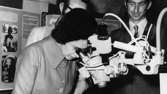 Queen Elizabeth looks through a microscope during her visit to Haywards Heath in 1971 to open Sightsavers' new head office.
