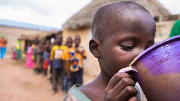 A small child receives his annual dose of medication to protect him from trachoma.