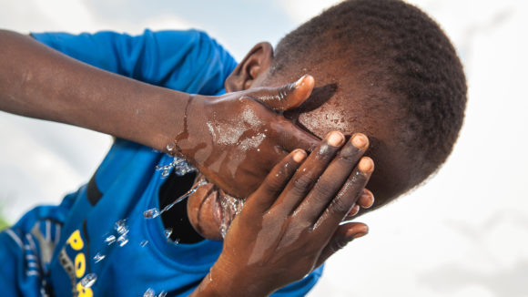 A boy washes his face to prevent the spread of trachoma infection.
