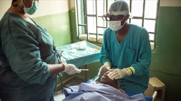Surgeons operate on a trachoma patient.