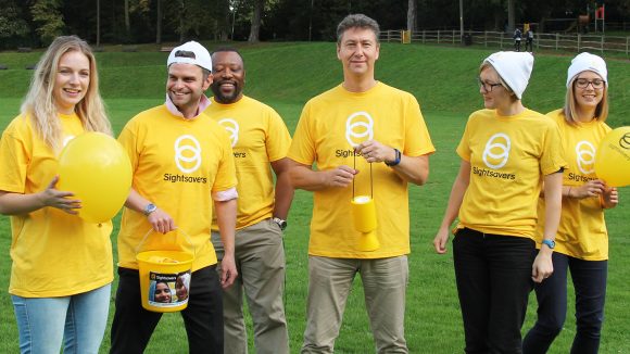 Group of people wearing Sightsavers t-shirts