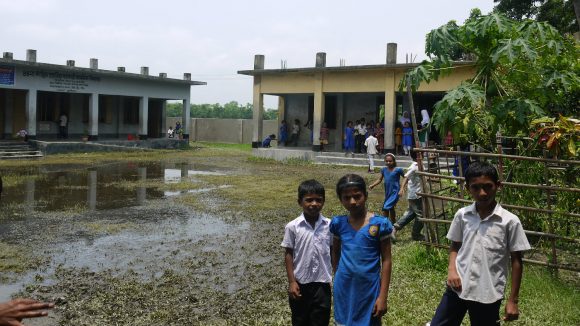 Children stand outside their school in Bangladesh.
