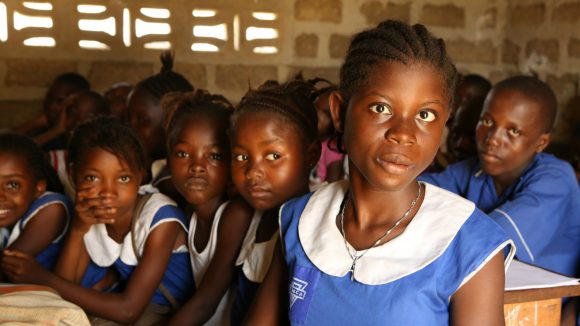 A visually impaired girl studies with her classmates in Sierra Leone.