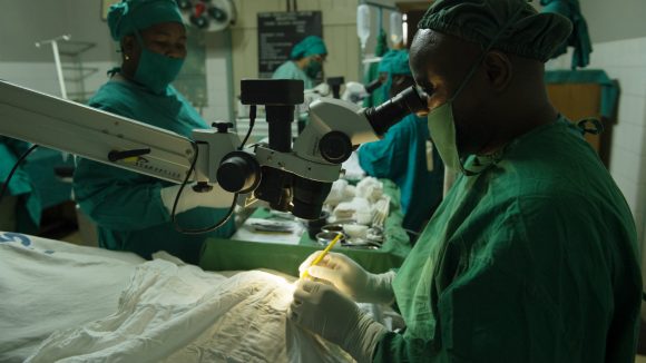 A doctor performs cataract surgery in Tanzania.