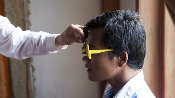 A man undergoes an eye examination in Cambodia.