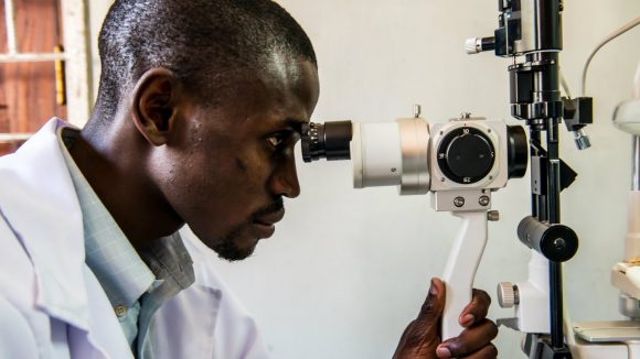 A health worker uses eye care equipment in Malawi.