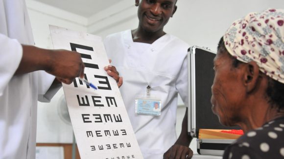 A woman reads from a chart during a sight test in Mozambique.