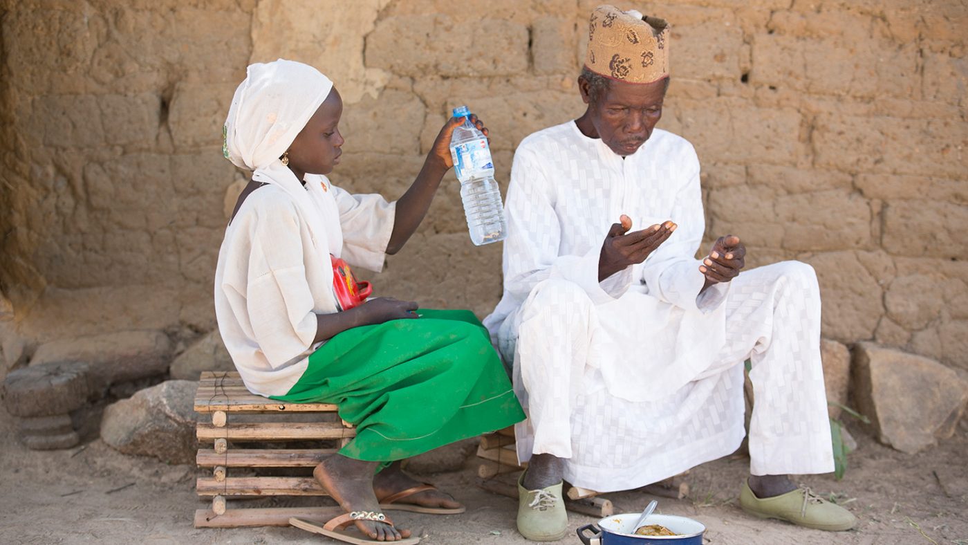 Dorcas sits with her grandfather.