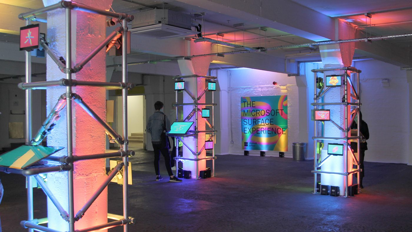 A room at the exhibition featuring tablet computers mounted to pillars.