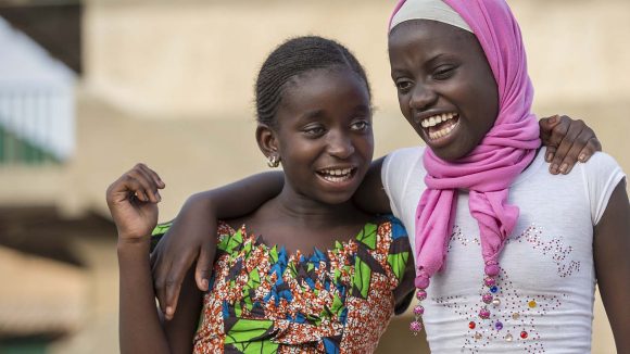 Two young girls with arms around each other