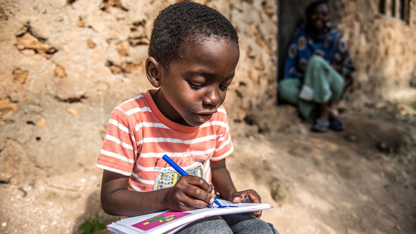 Fahad is at home and happily colouring in.