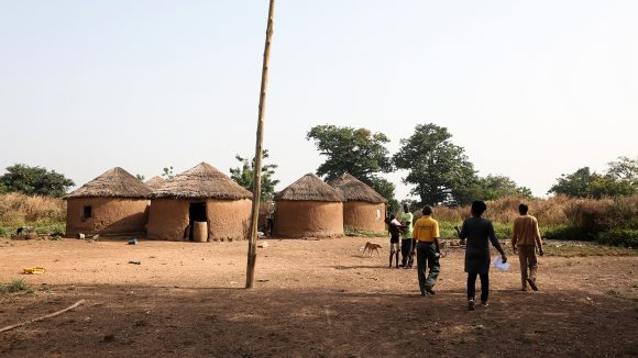 A village in the Yendi region of Ghana, featuring circular mud huts and trees.