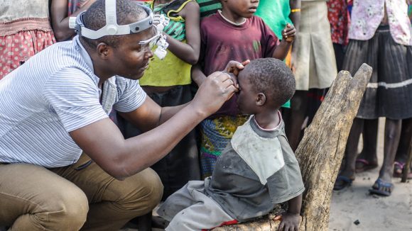 Pumelo having his eyes screened for trachoma.