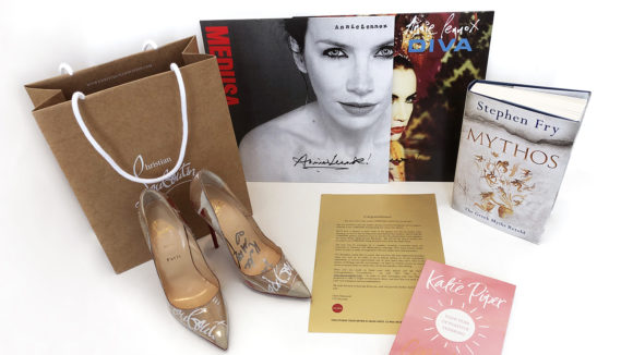 A collection of the items that Sightsavers is auctioning, including signed shoes, records and books.