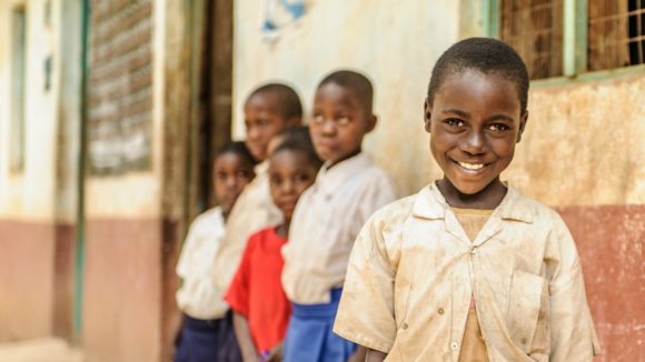 Zuhara from Tanzania stands outside her primary school