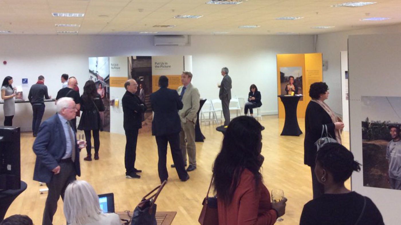 An exhibition space with people milling around.