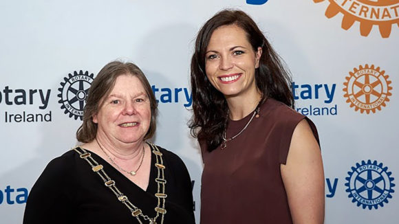 Monica Robertson and Ciara Smullen in front of a backdrop showing Rotary Ireland logos.