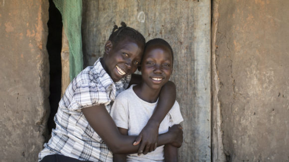 brother and sister hugging and smiling