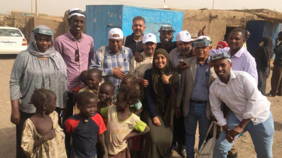A group of participants from the Sudan Tropical Data training stand together for a photo.