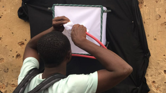 A man empties a mosquito exit trap