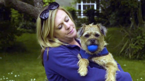A still from the My legacy video, showing a woman holding her dog.