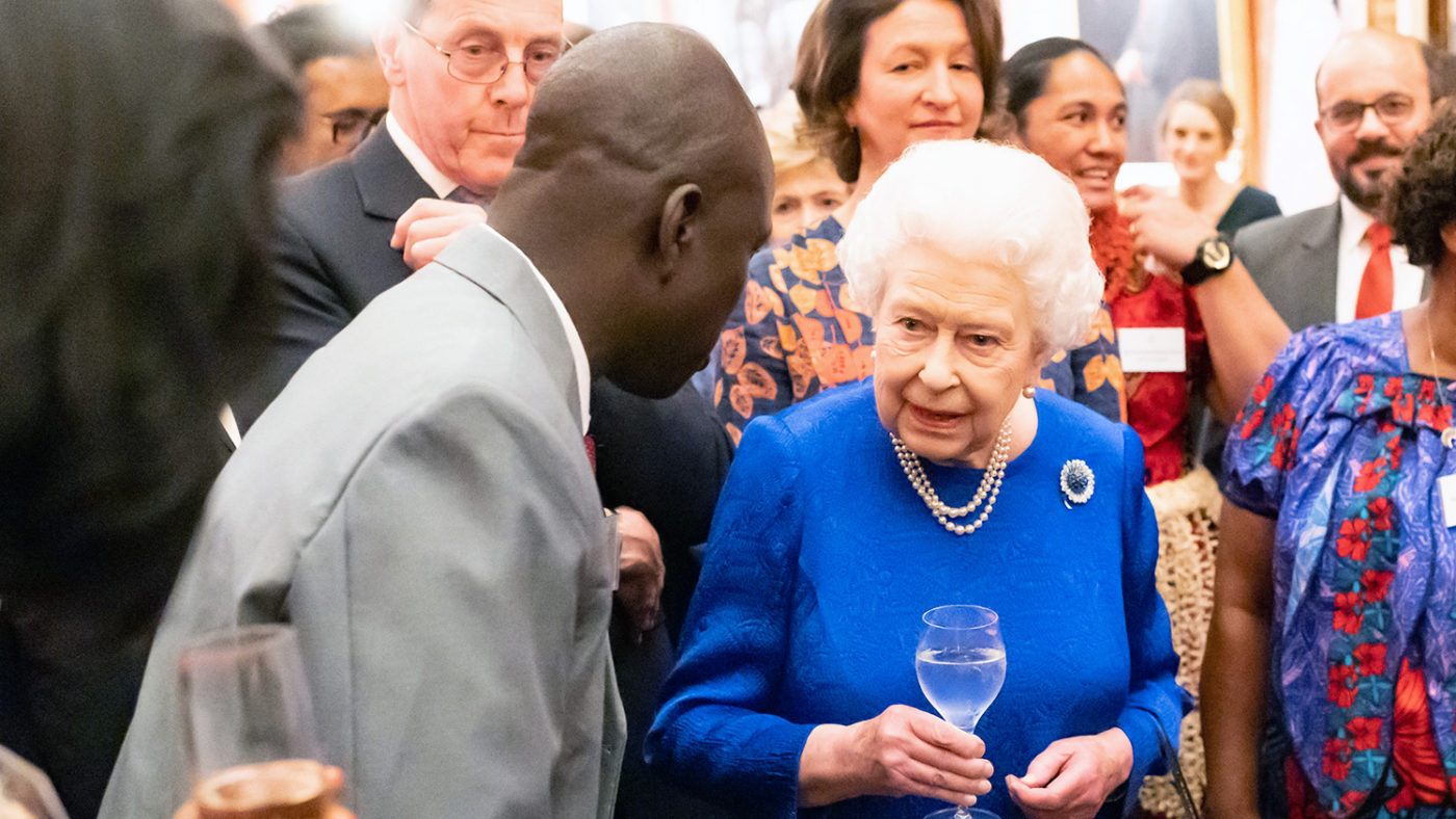 Samson Lokele talks to Queen Elizabeth at Buckingham Palace.
