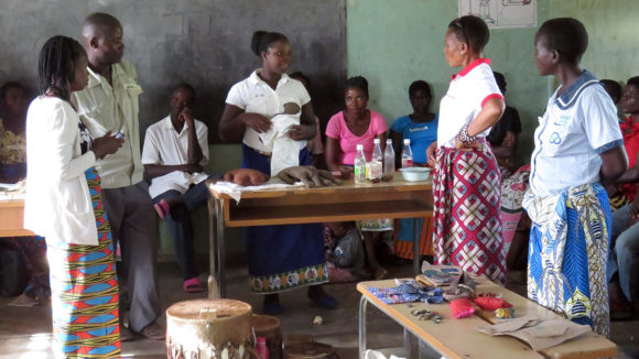 Adults talking in a classroom.