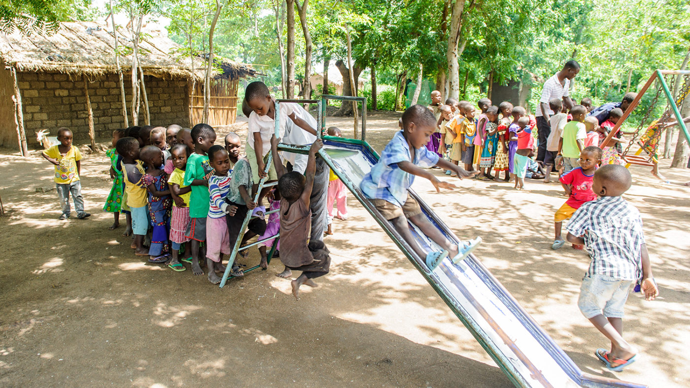 Children playing on a slide.