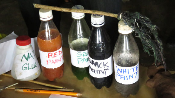Homemade paint in drinks bottles.