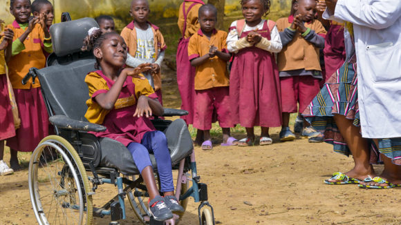 Lesline, who uses a wheelchair, with her classmates at her inclusive school in Cameroon.