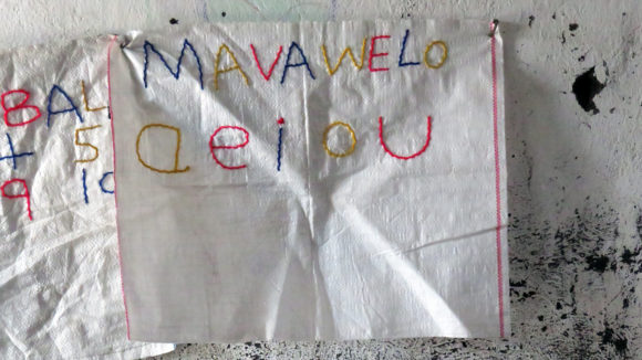 Stitched letters on a plastic sheet.