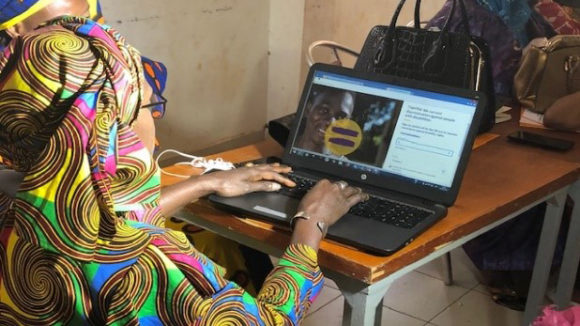 A woman signs an online petition.