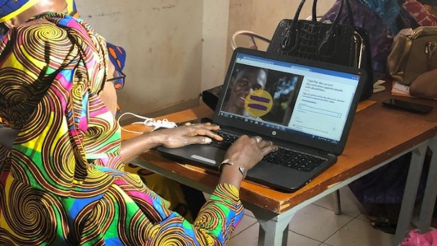 A woman signs an online petition.