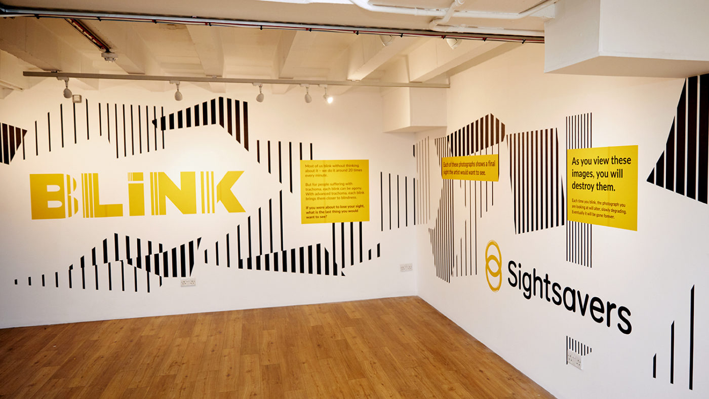 Sightsavers' BLINK exhibition in London, featuring the BLINK logo and the Sightsavers logo.