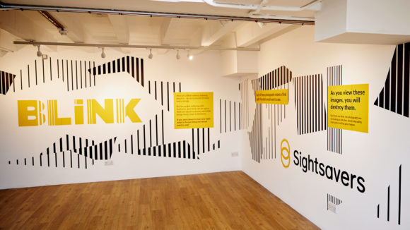 Sightsavers' BLINK exhibition in London, featuring the BLINK logo and the Sightsavers logo.