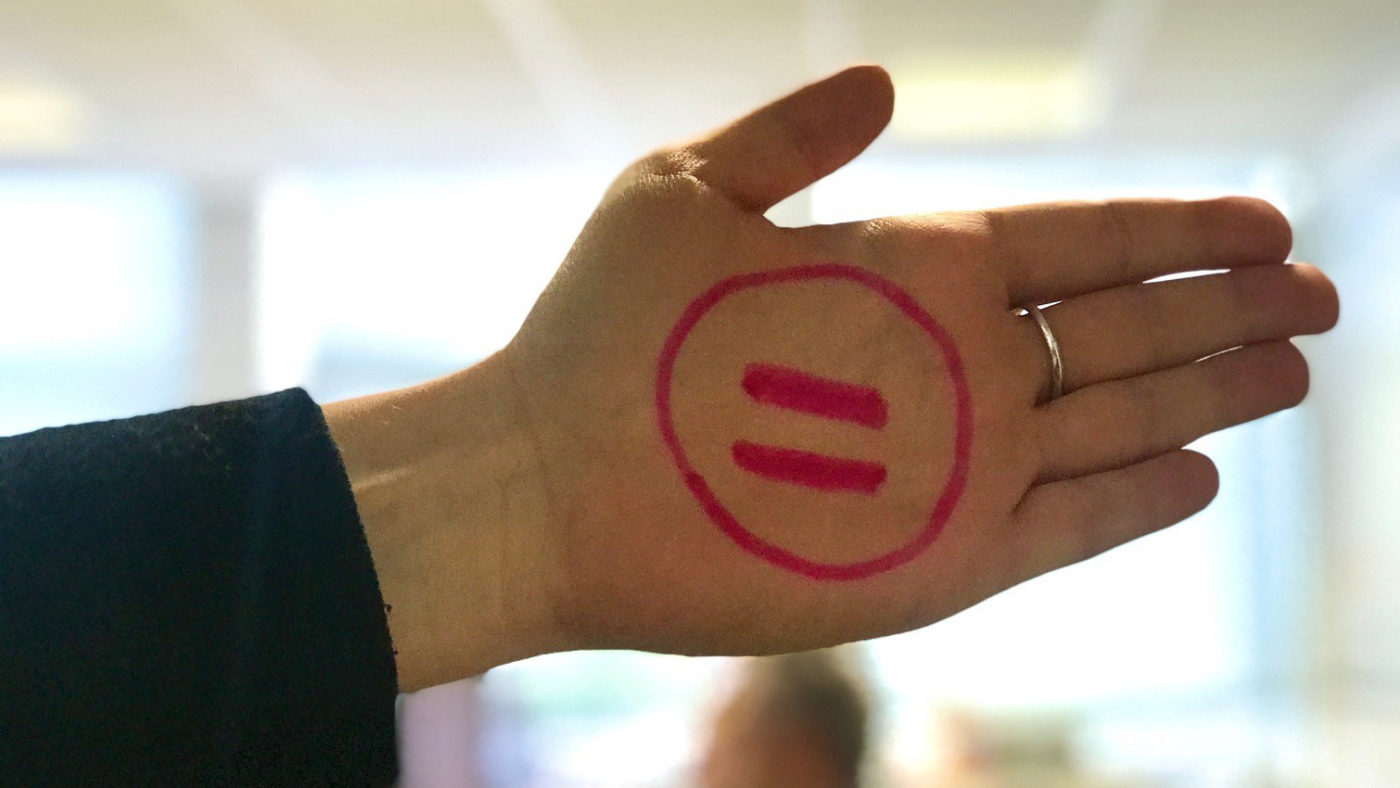 A hand with an equals sign inside a circle drawn on it.