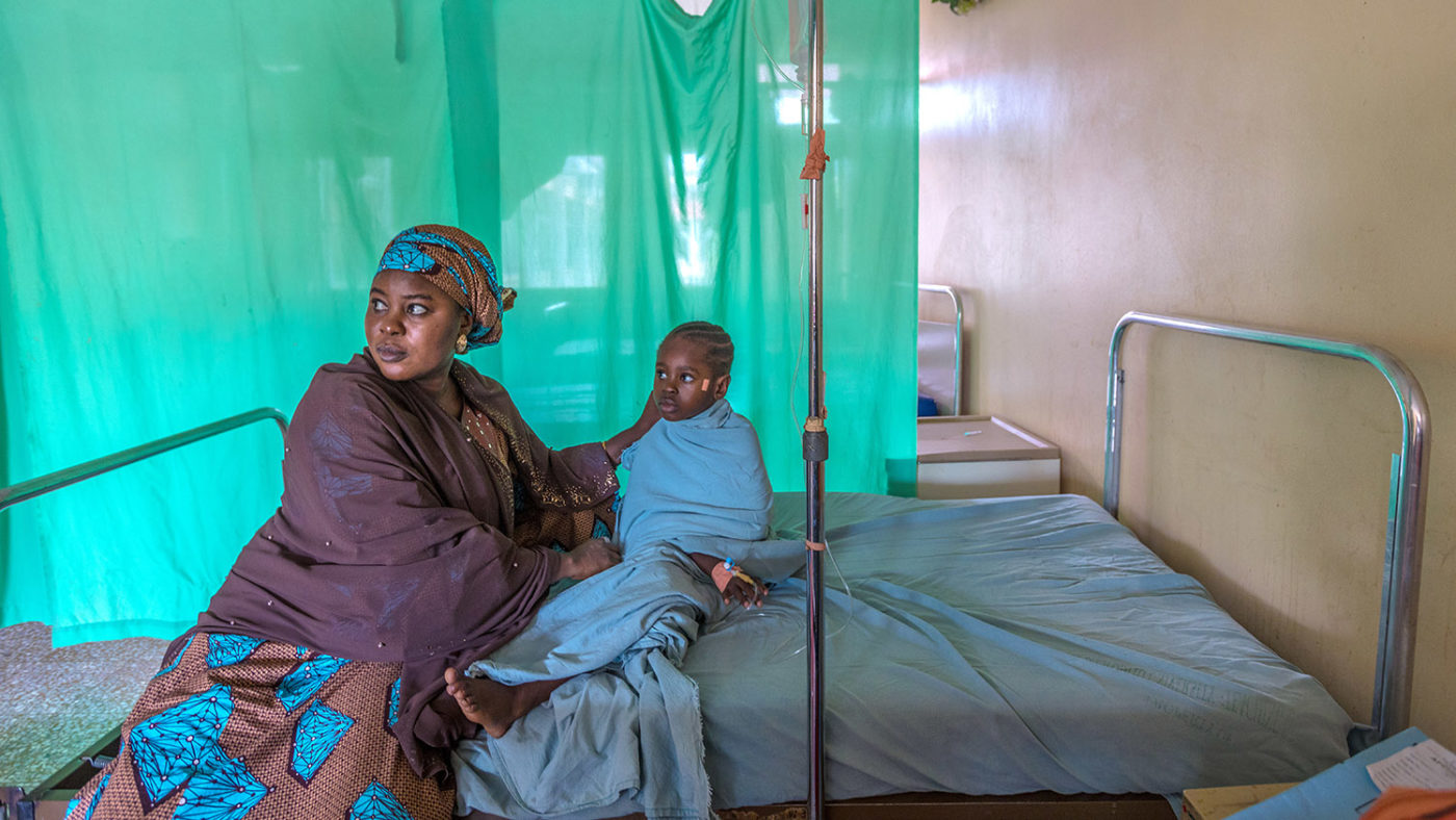 Shafa and Khadijah wait on a hospital bed before her operation.