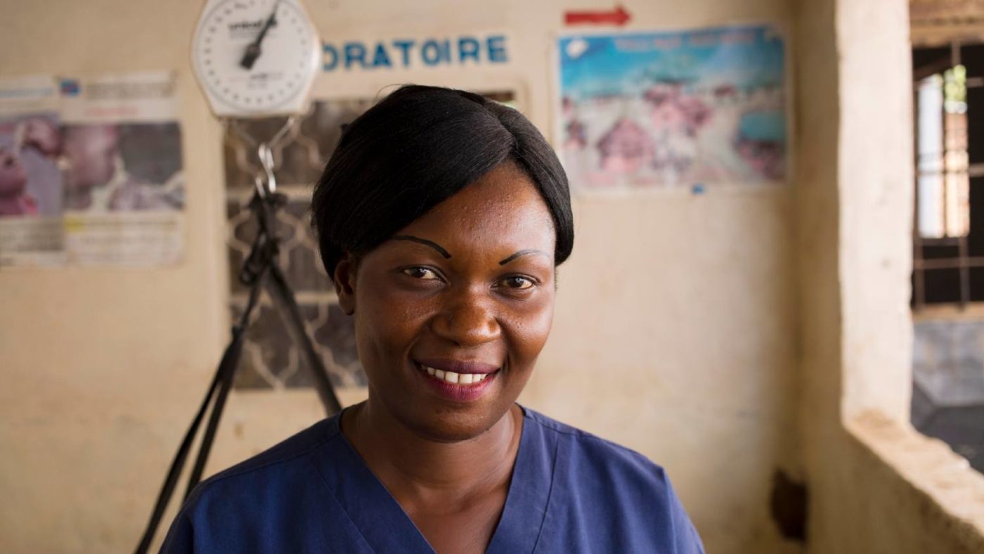 A female nurse stands for a portrait in a community health centre.