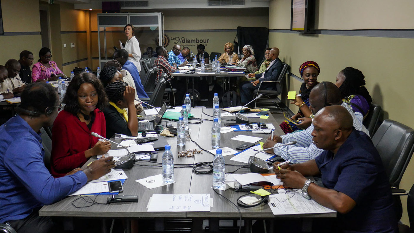 A group of people sit around tables.