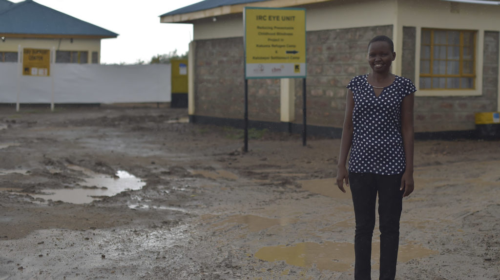 Elizabeth stands outside an eye clinic.
