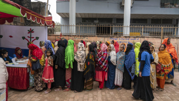 Women wait in line for eye screening tests.