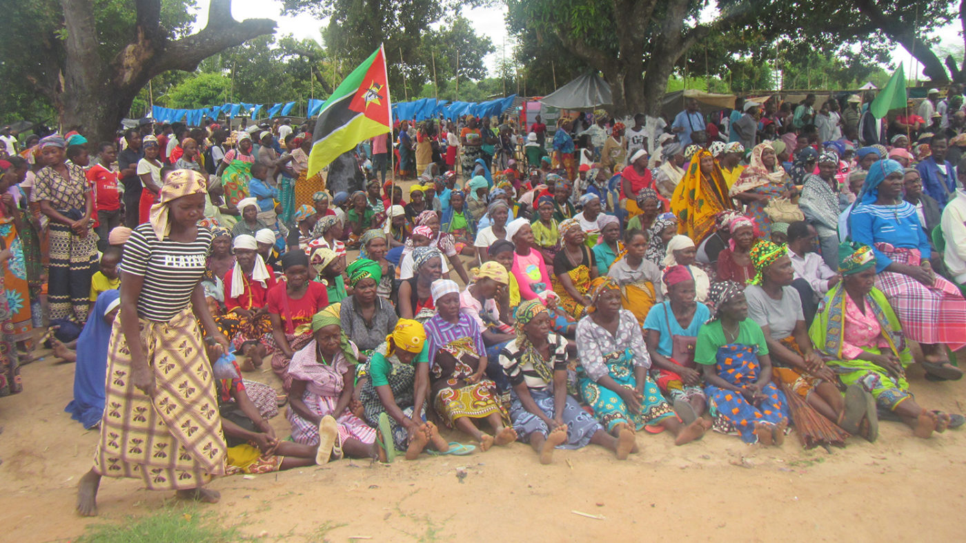 A large group of people gather outside.