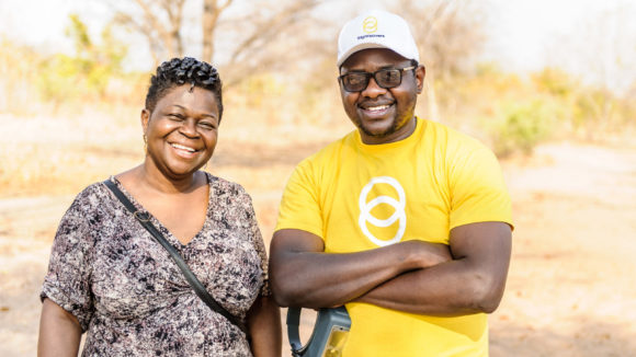 Givemore Mafukidze, wearing a Sightsavers tshirt, stands with Dr Agatha Aboe.