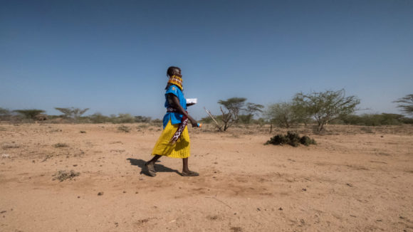 Community health volunteer Ngurotin Lung'Or walks through the bush in the Turkana region of Kenya to perform eye checkups.