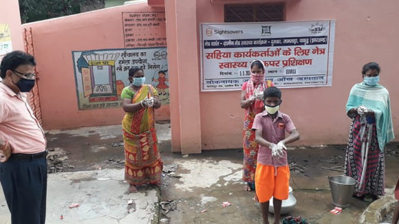 Volunteers demonstrate the importance of washing hands.