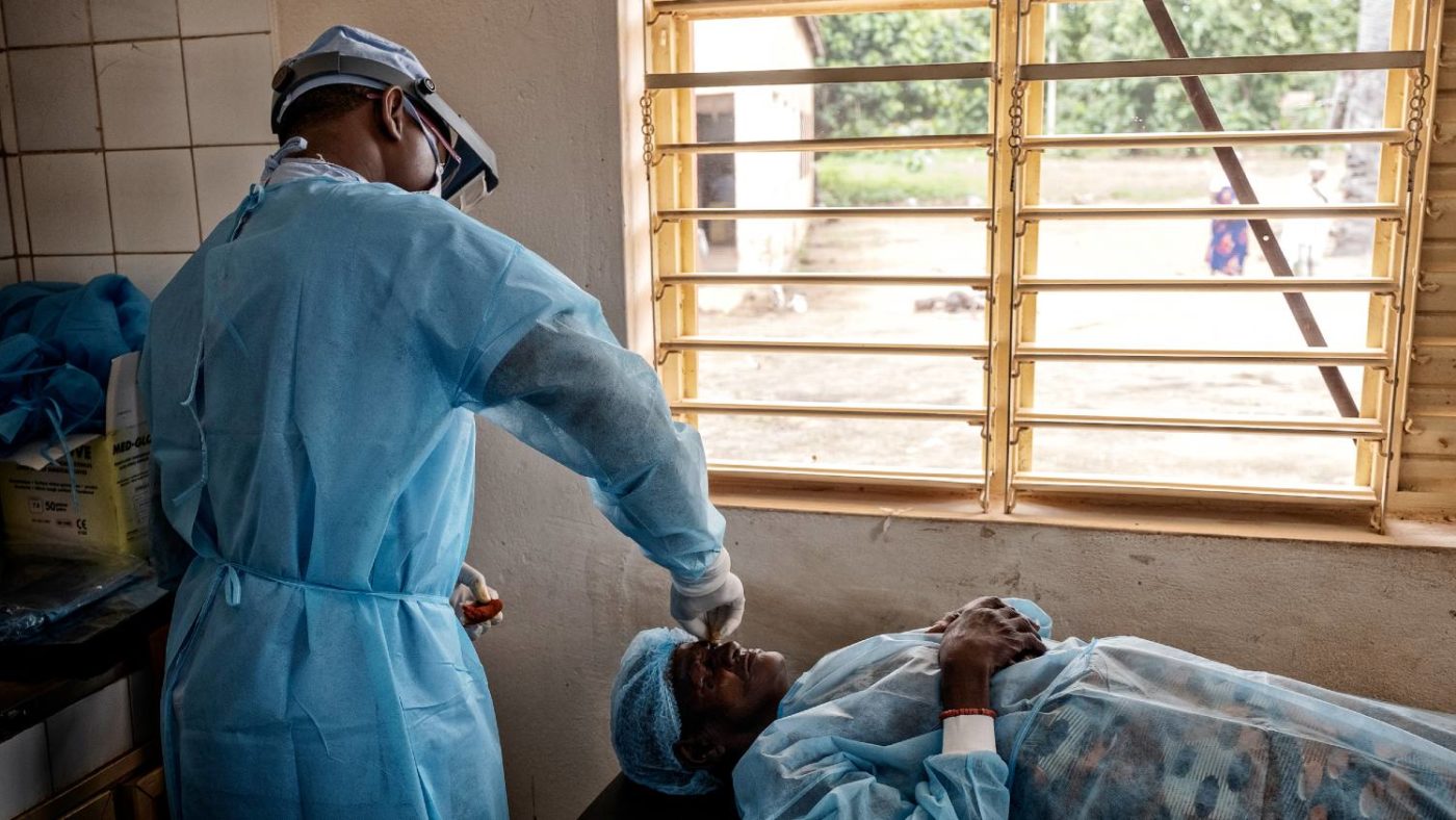 A surgeon performs trachoma surgery on a patient.