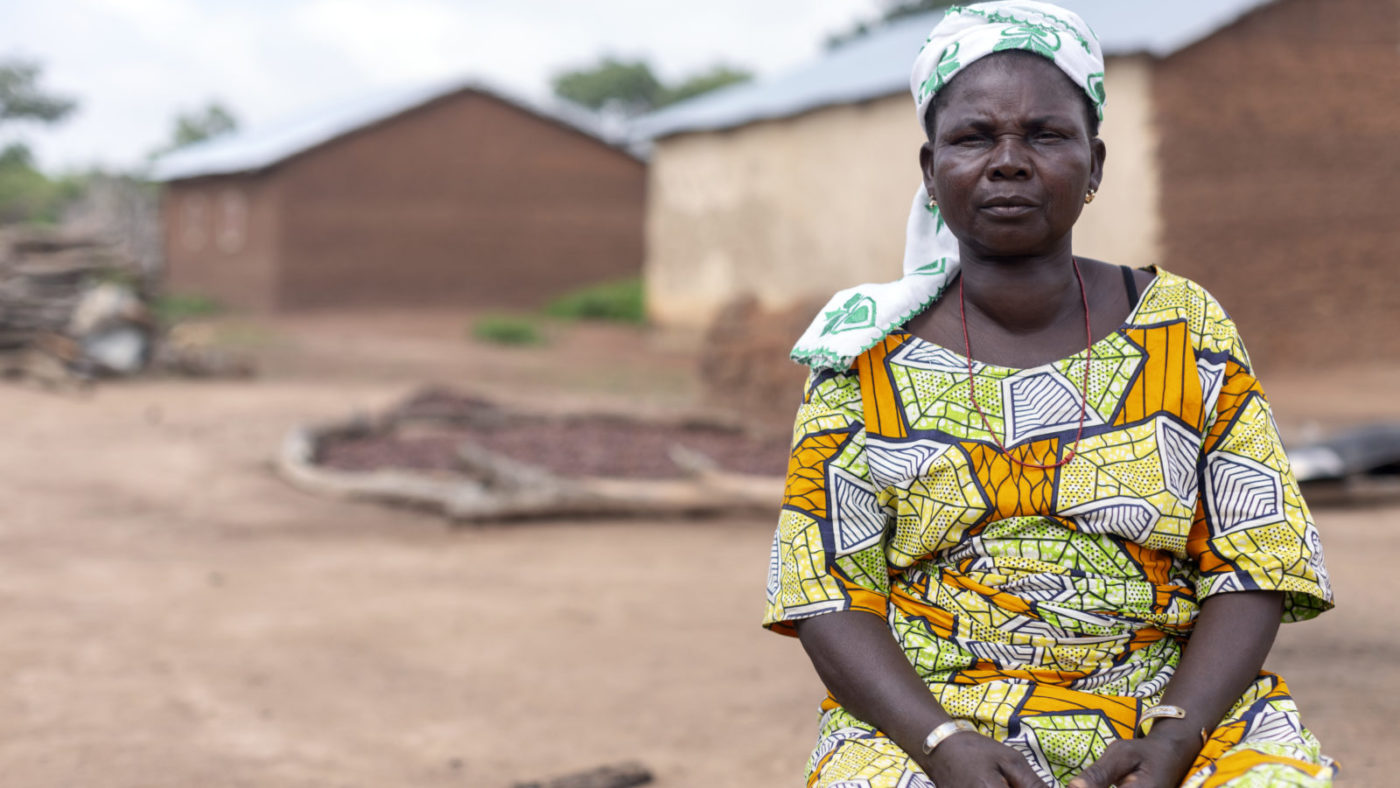 Gani stands outside her home.