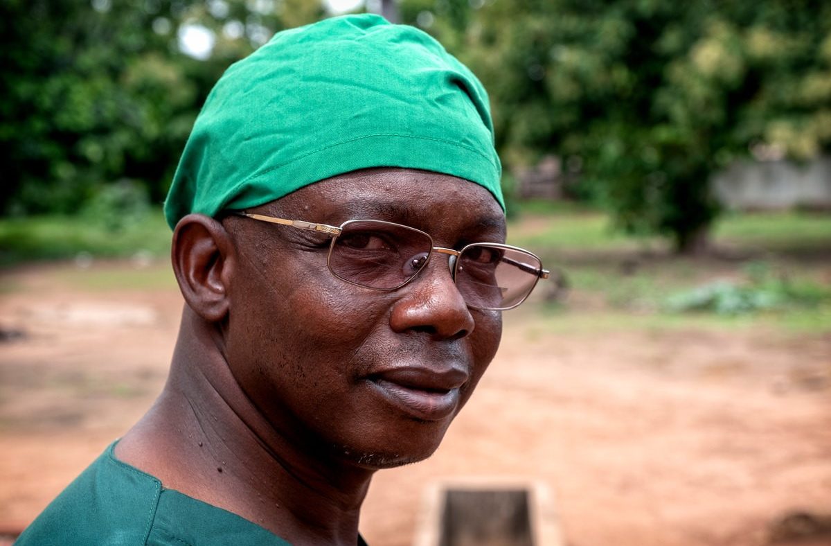Dr Guera in green scrubs.